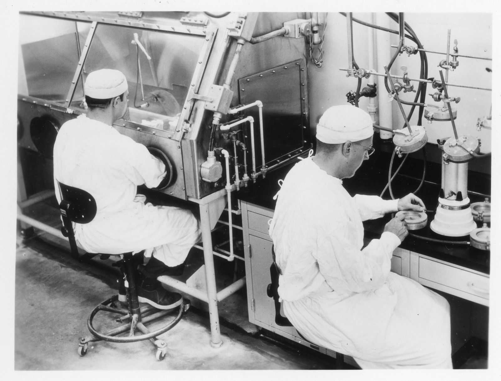 Historic photograph of US scientists researching germs and bacteria in 1957.