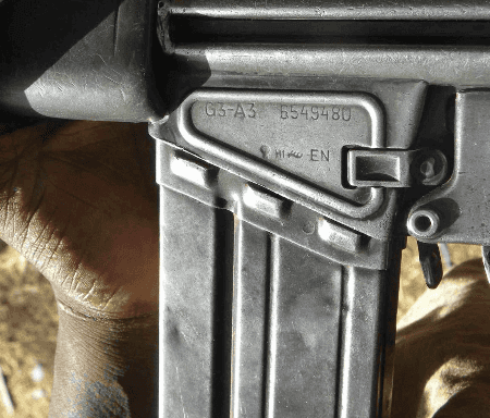 A closeup photo of markings on a G3A3 rifle in Somalia. The markings say 'G3-A3 6549480 EN'