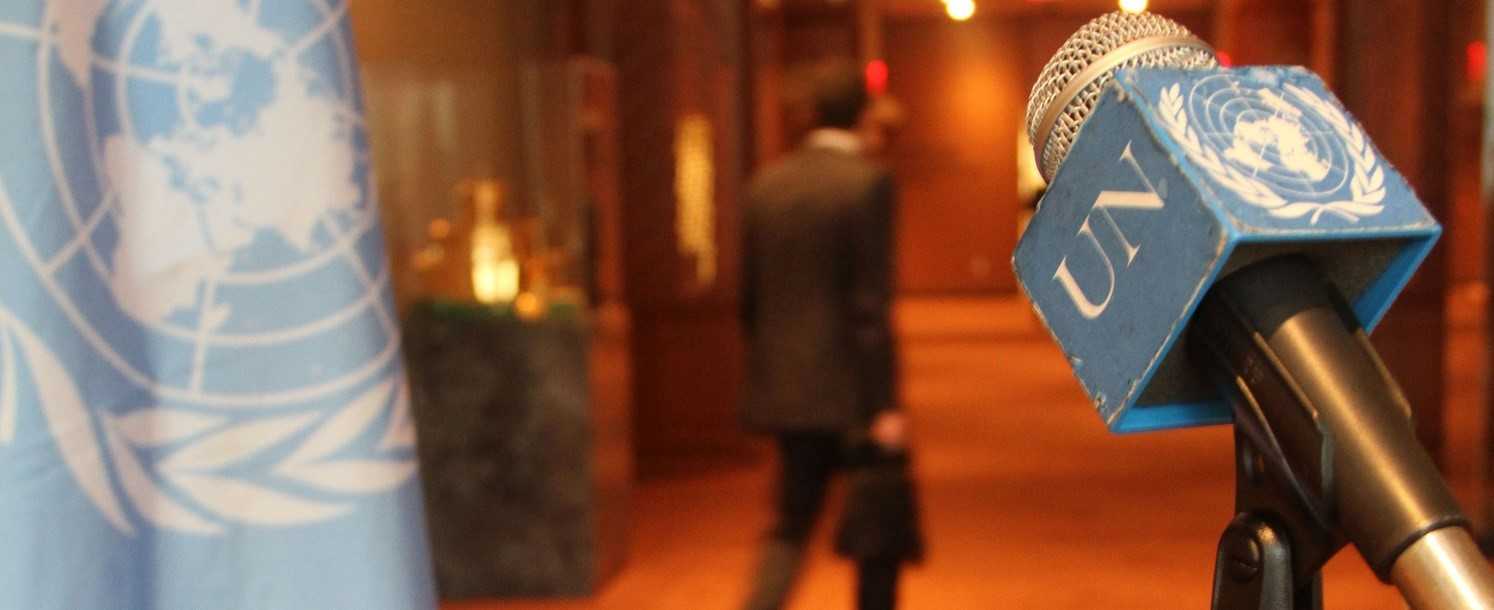 A closeup photo of a microphone with the logo of the United Nations.