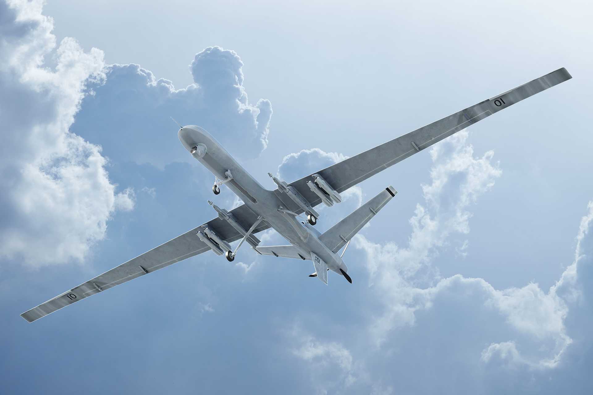 Photo of a drone travelling through blue skies seen from below.