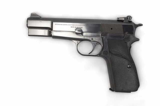 A closeup photo of a Browning HP 9mm pistol.
