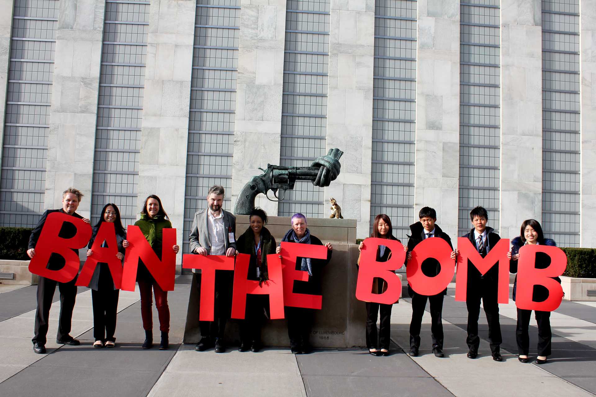 Photograph of people in New York holding letters that add up to sentence: “Ban the bomb”. The picture was taken in 2017 during the Women´s March to Ban the Bomb by Women’s International League for Peace and Freedom (WILPF).
