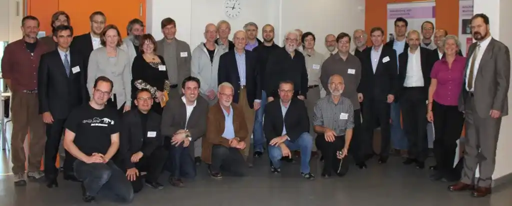 Group portrait with a total of 32 white people in three rows, including three women.